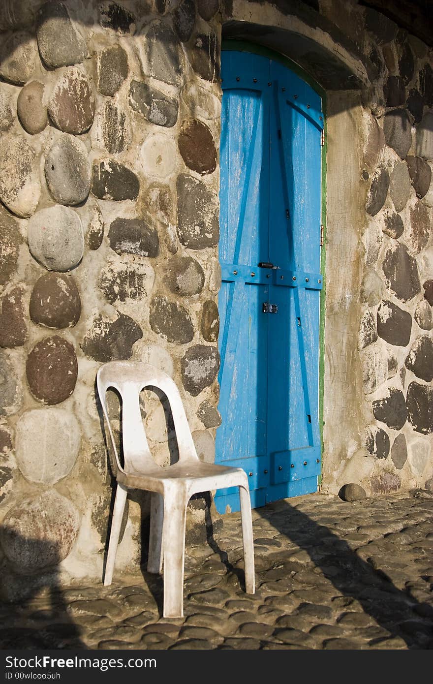 Shadow play on a blue door and stone wall. Shadow play on a blue door and stone wall