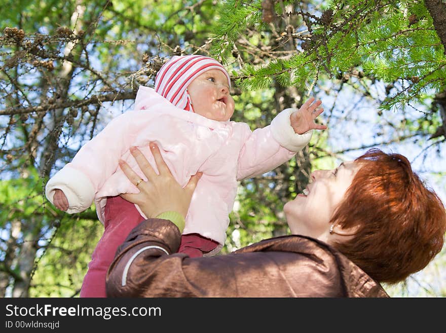 Small baby with mother in the forest