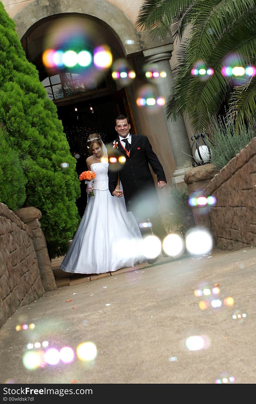 A wedding couple and bubble confetti. A wedding couple and bubble confetti