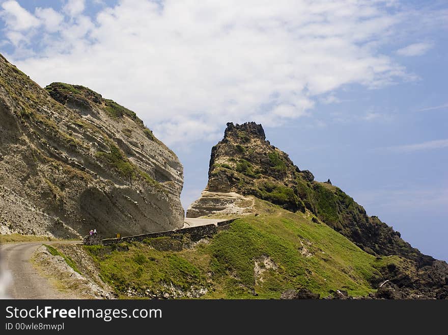 A mountain path cut by a road. A mountain path cut by a road