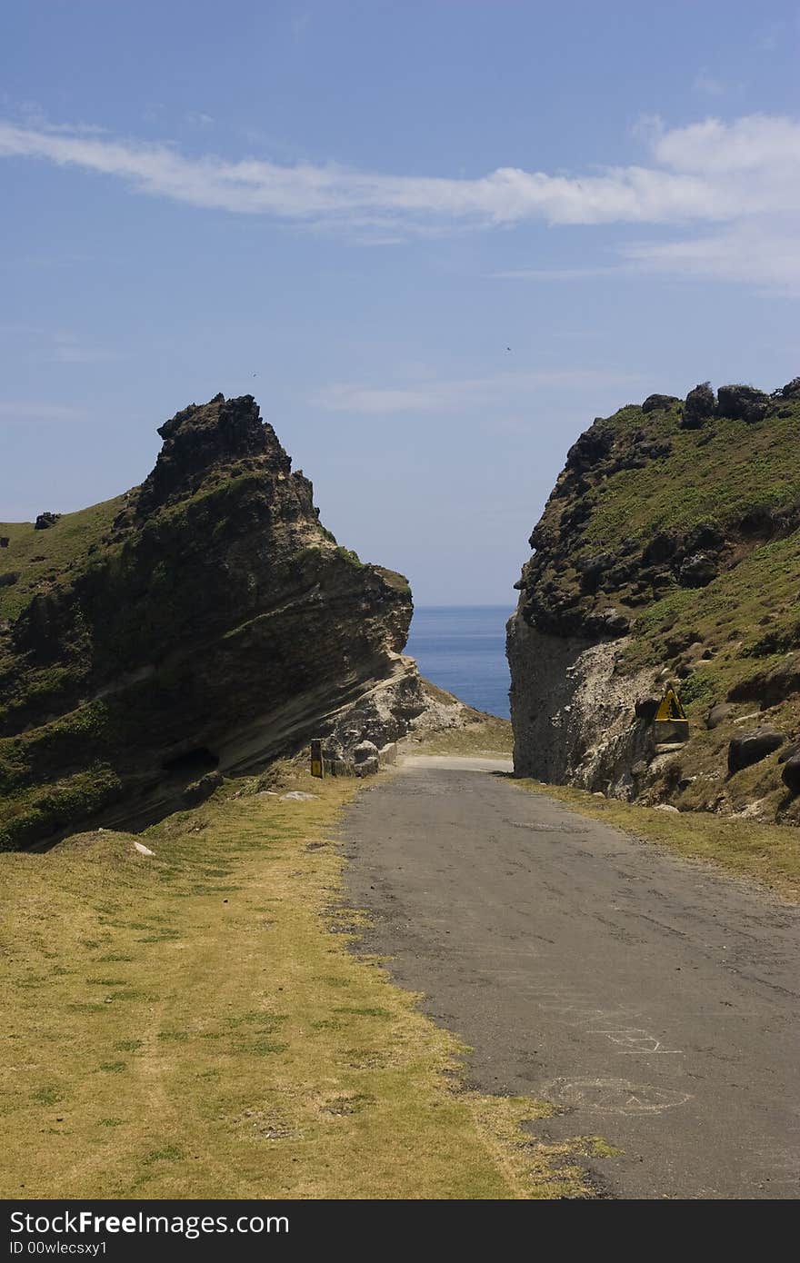 A mountain path cut by a road. A mountain path cut by a road