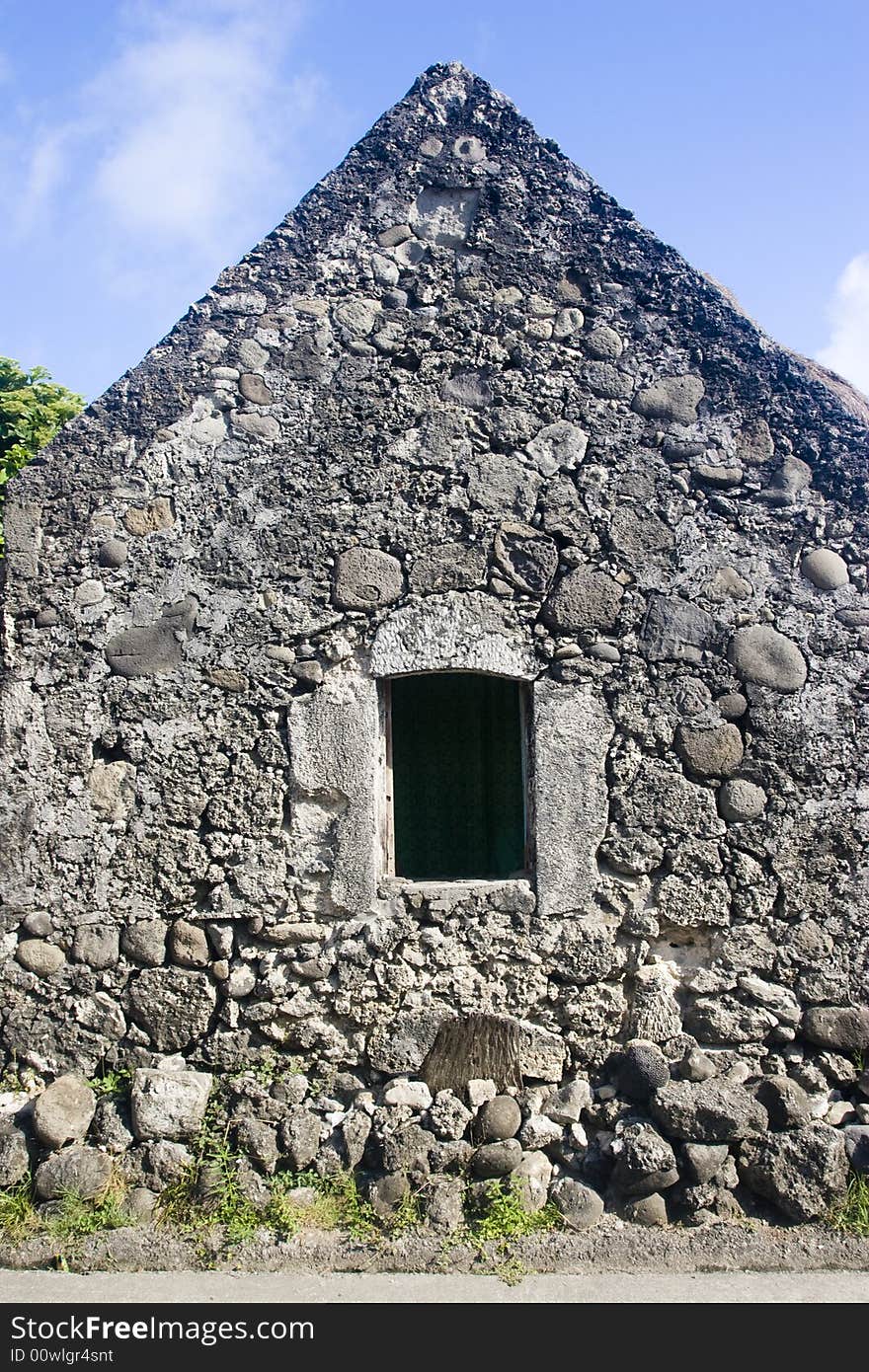 A stone house with an open window