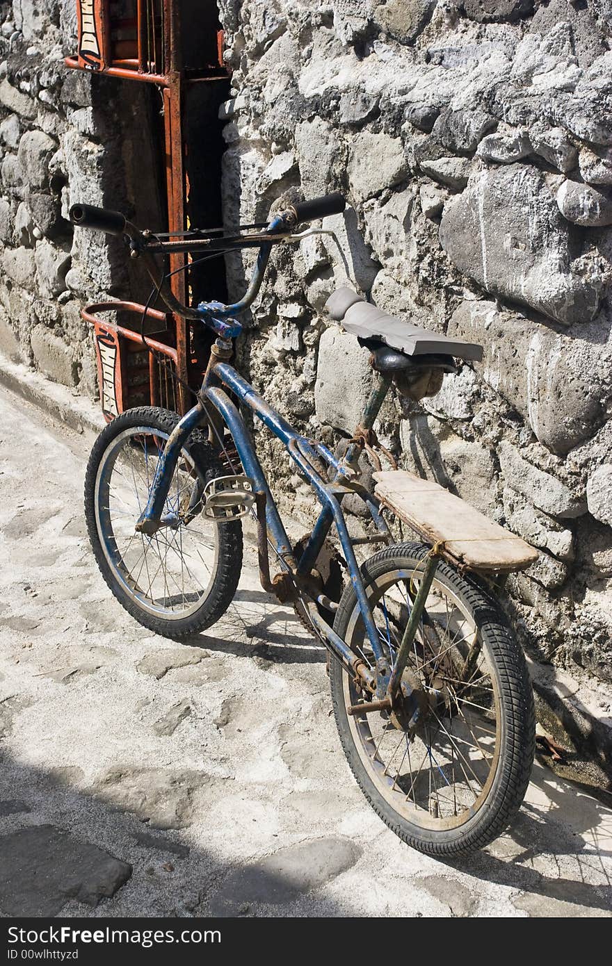 Bike propped up against a stone wall. Bike propped up against a stone wall