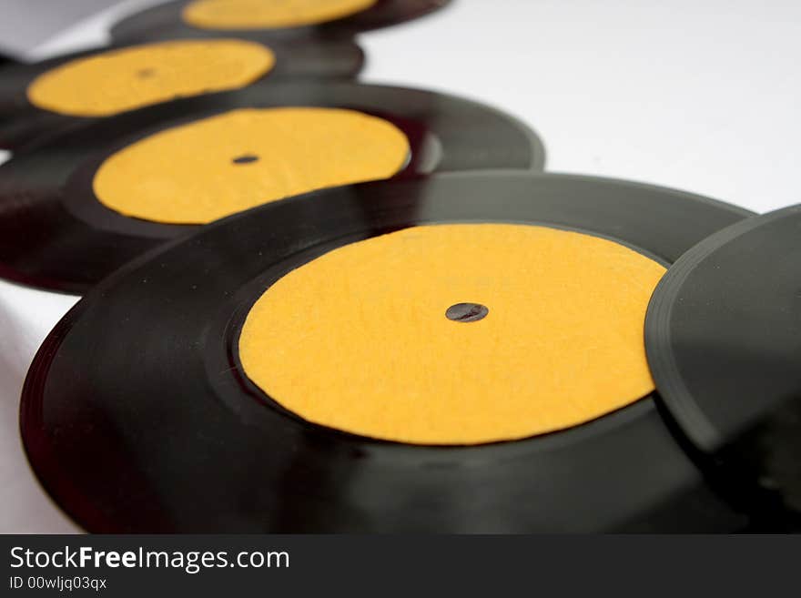 A bunch of old records on a table. A bunch of old records on a table