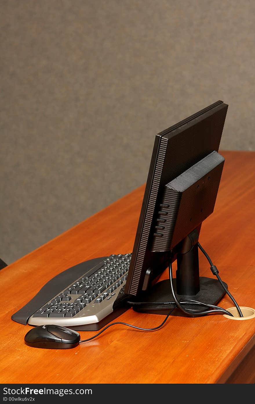 A computer on a desk in a office. A computer on a desk in a office