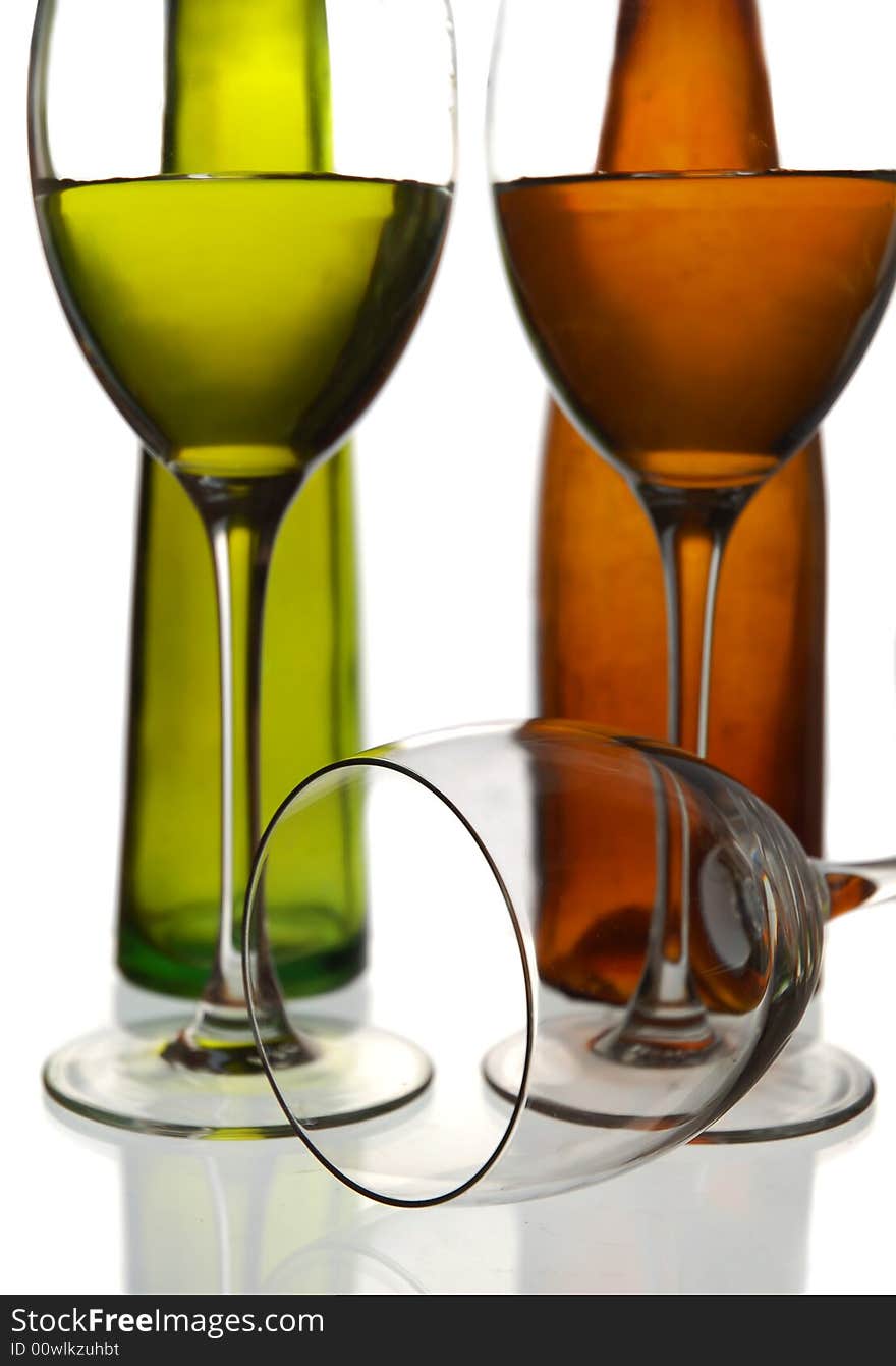 Wine bottles and two glasses with water against a white background. Wine bottles and two glasses with water against a white background