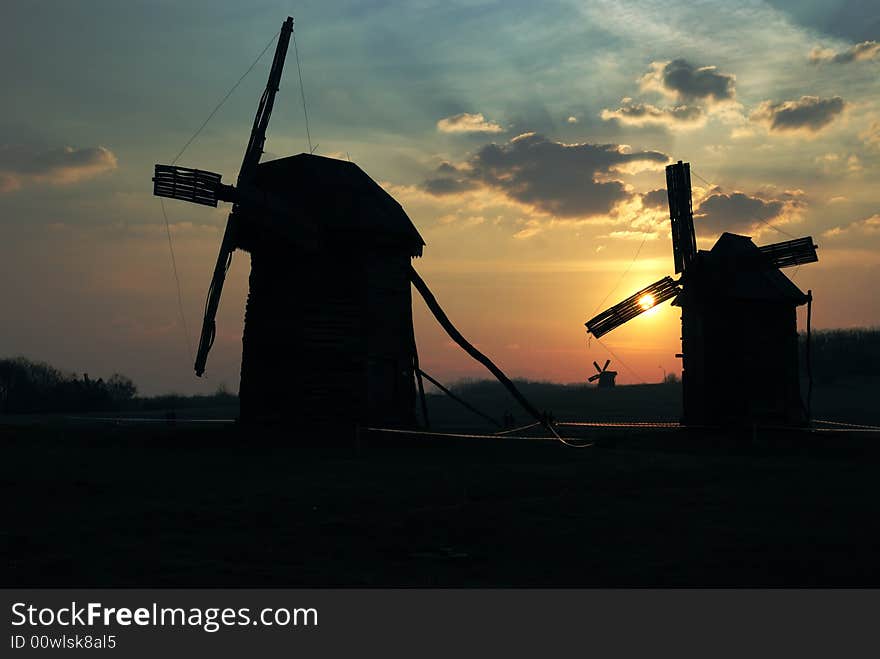 Old windmills against  sunset sky