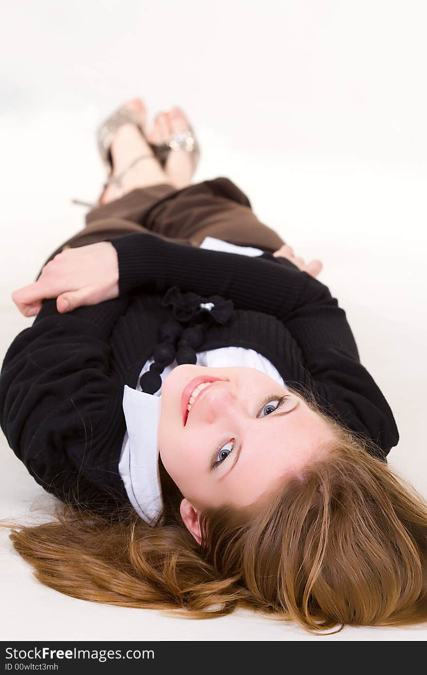 Pretty girl dressed business clothes laying on the floor isolated on white. Pretty girl dressed business clothes laying on the floor isolated on white