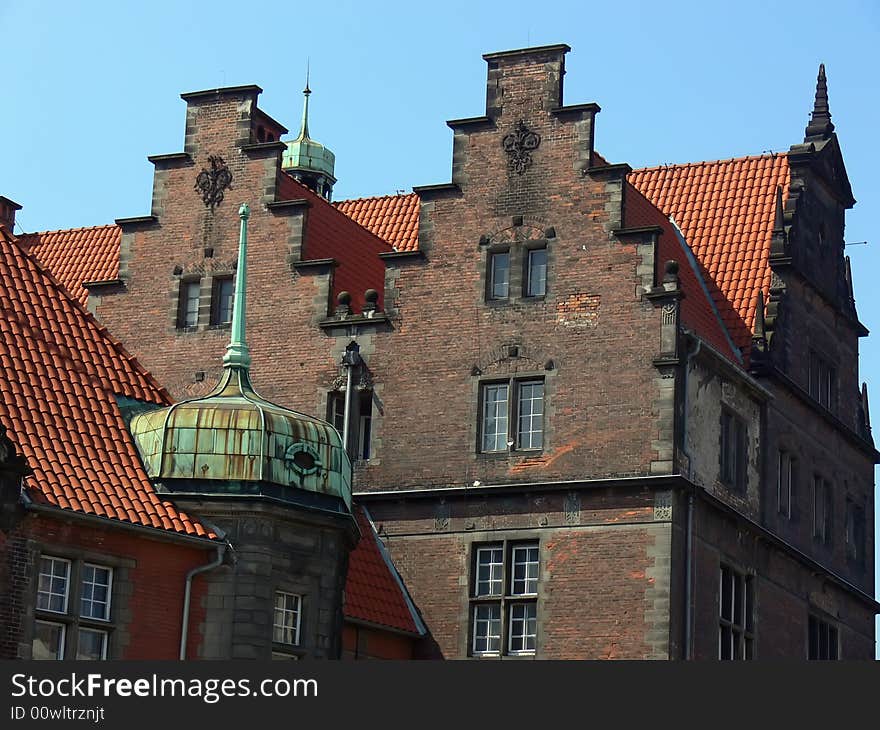 Tenement in old town of Gdańsk in Poland. Historic buildnig with red roof. Tenement in old town of Gdańsk in Poland. Historic buildnig with red roof.