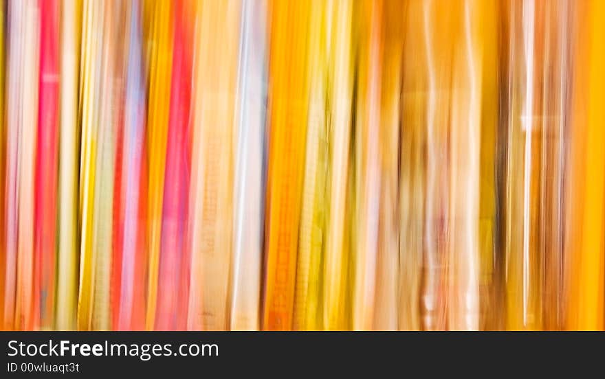 An intentional camera blur of a book shelf. An intentional camera blur of a book shelf.