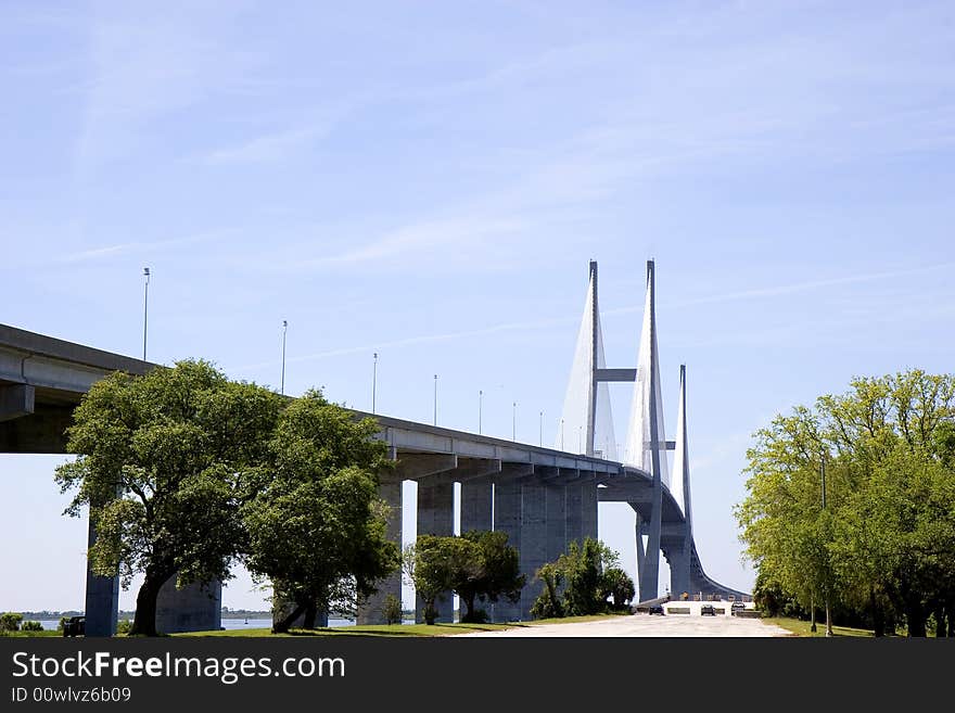 A new concrete suspension bridge next to an old closed road. A new concrete suspension bridge next to an old closed road