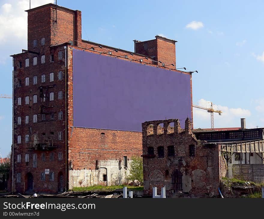 Old devastated buildings with big place for advertisement or banner.