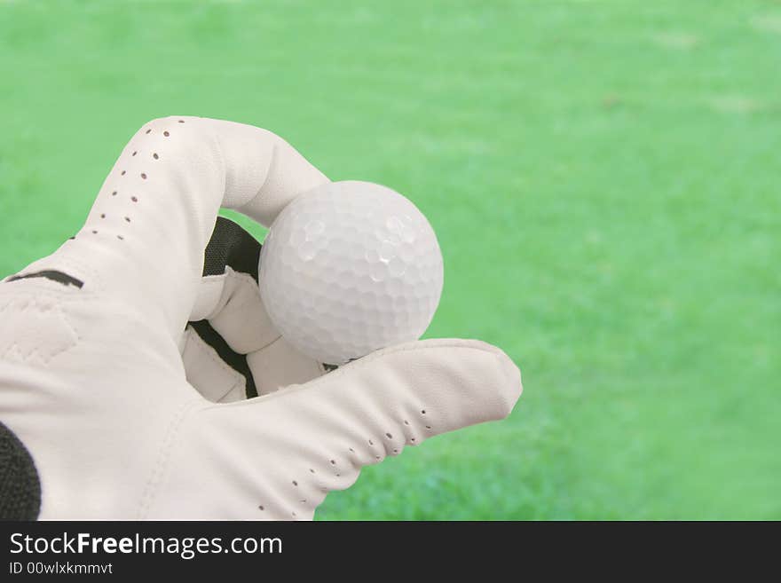 Hand holding a golf ball