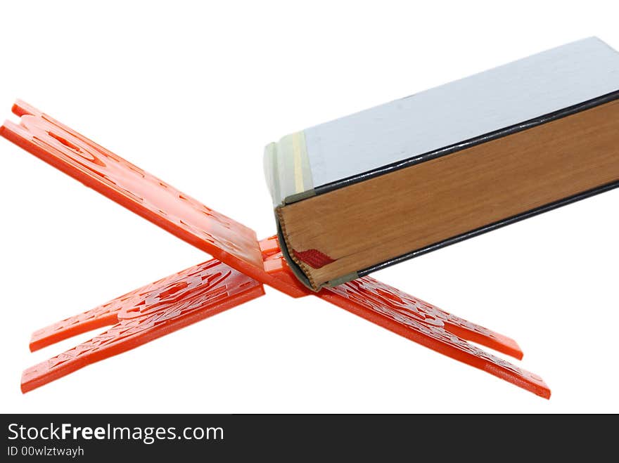 Reading a holy book or book of faith or seeking knowledge in the middle eastern world. book on a stand isolated on a white background with copy space