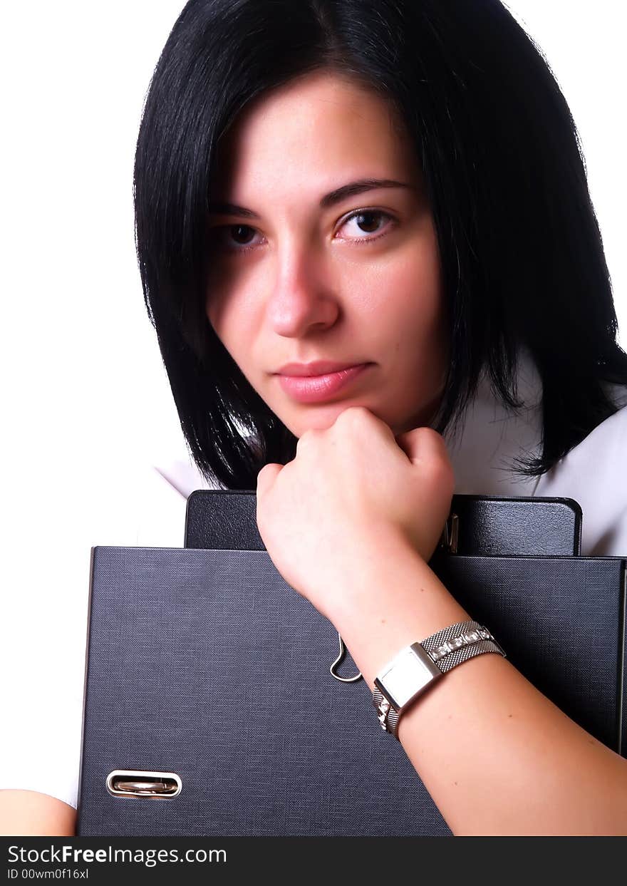 A portrait about a young pretty happy businesswoman with black hair who is holding some folders and she is wearing a white shirt. A portrait about a young pretty happy businesswoman with black hair who is holding some folders and she is wearing a white shirt