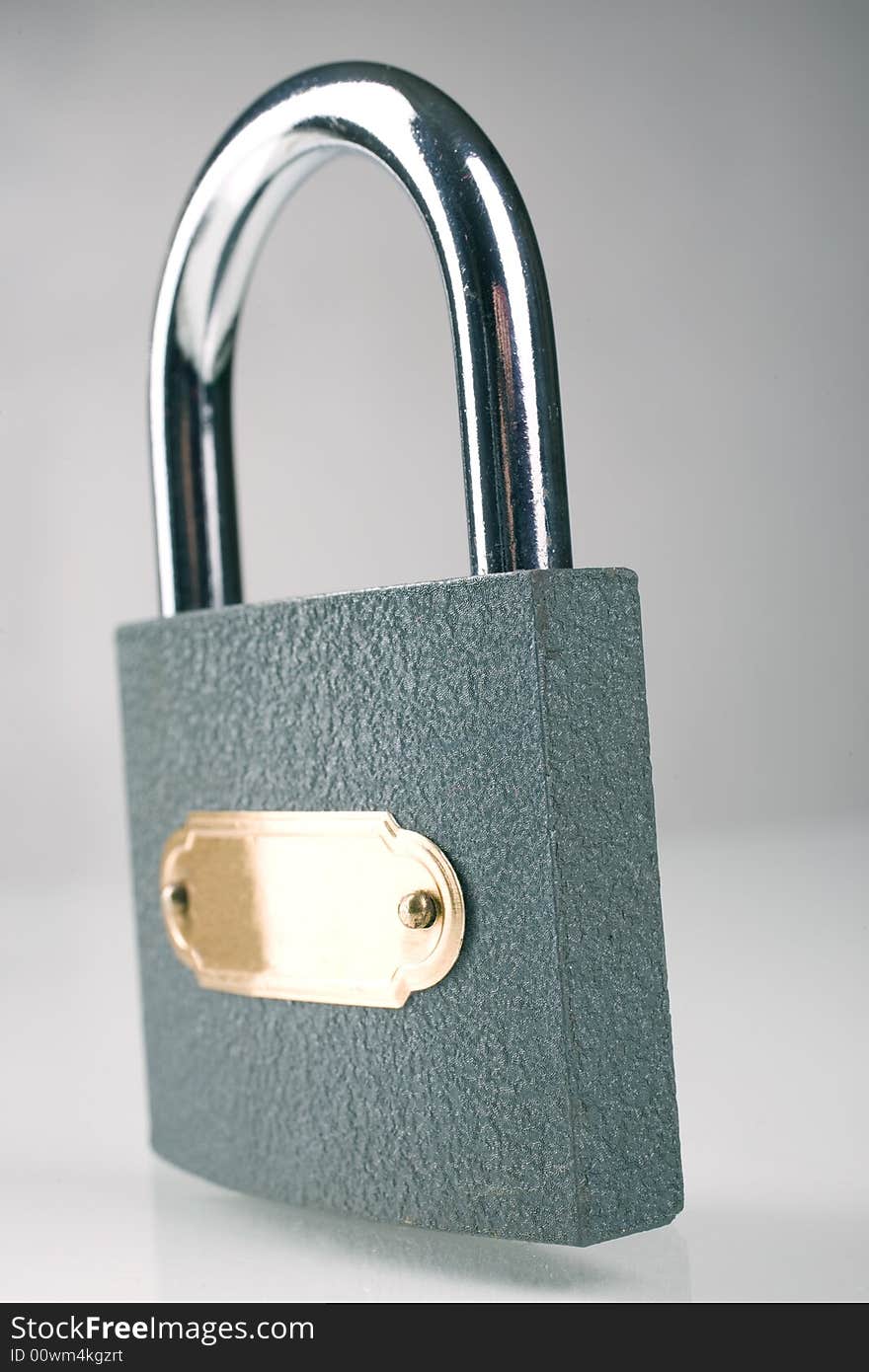 Metal padlock over grey