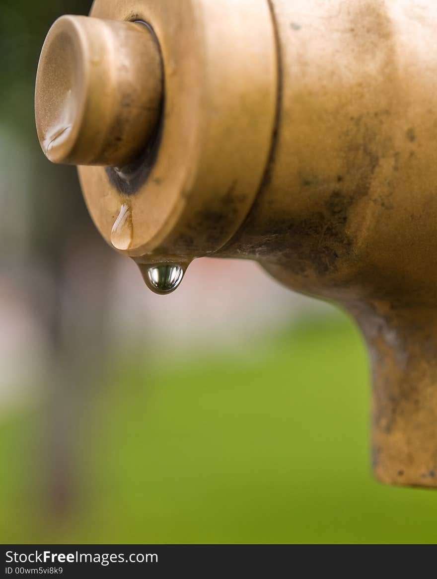 Macro of drop pouring from a fountain