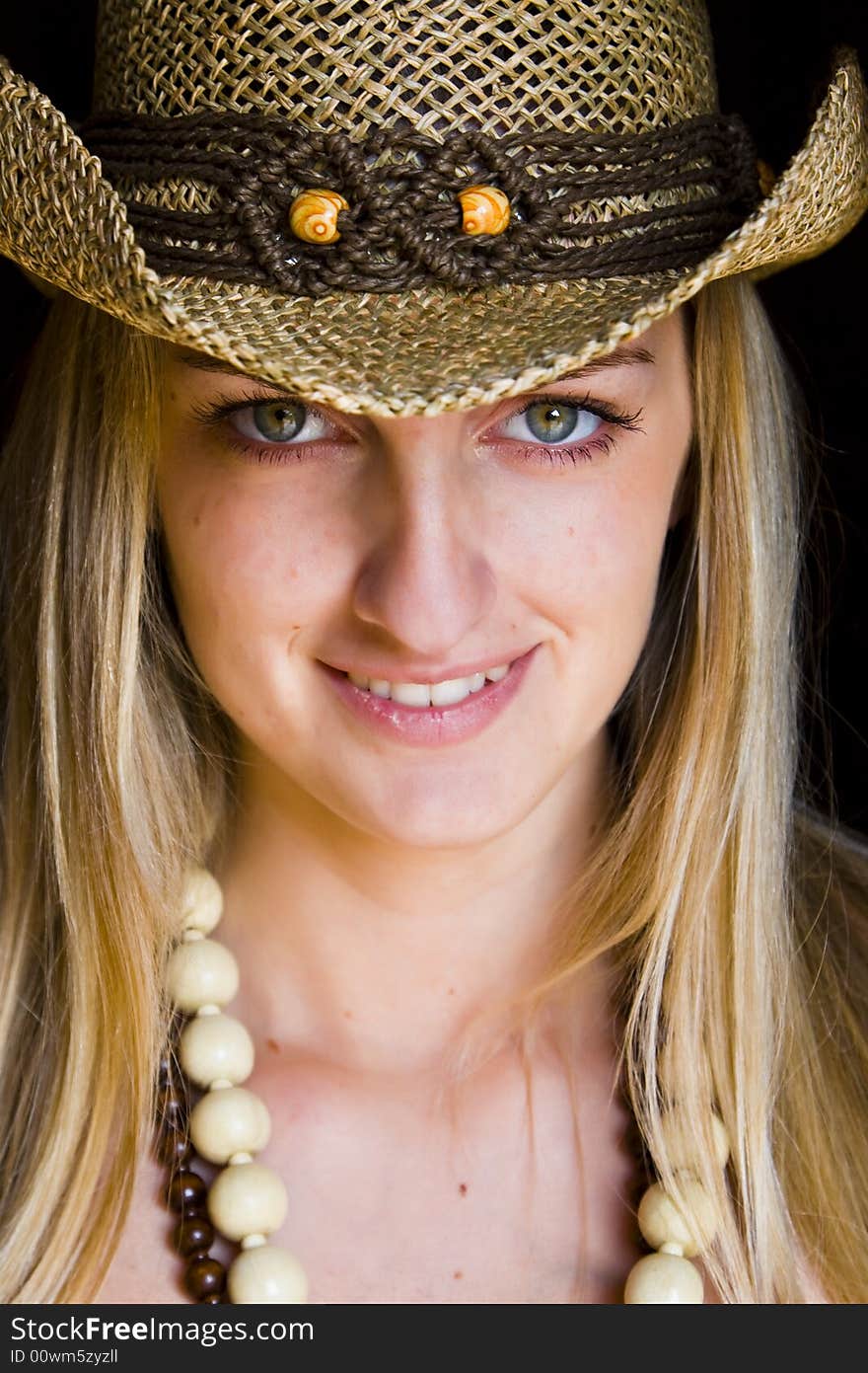 Smiling green eyed blonde woman with hat. Smiling green eyed blonde woman with hat.