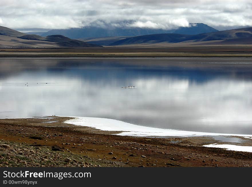 The sacred lake of Tibet,the Sheep Lake, reflecting the white clouds and blue sky. The sacred lake of Tibet,the Sheep Lake, reflecting the white clouds and blue sky.