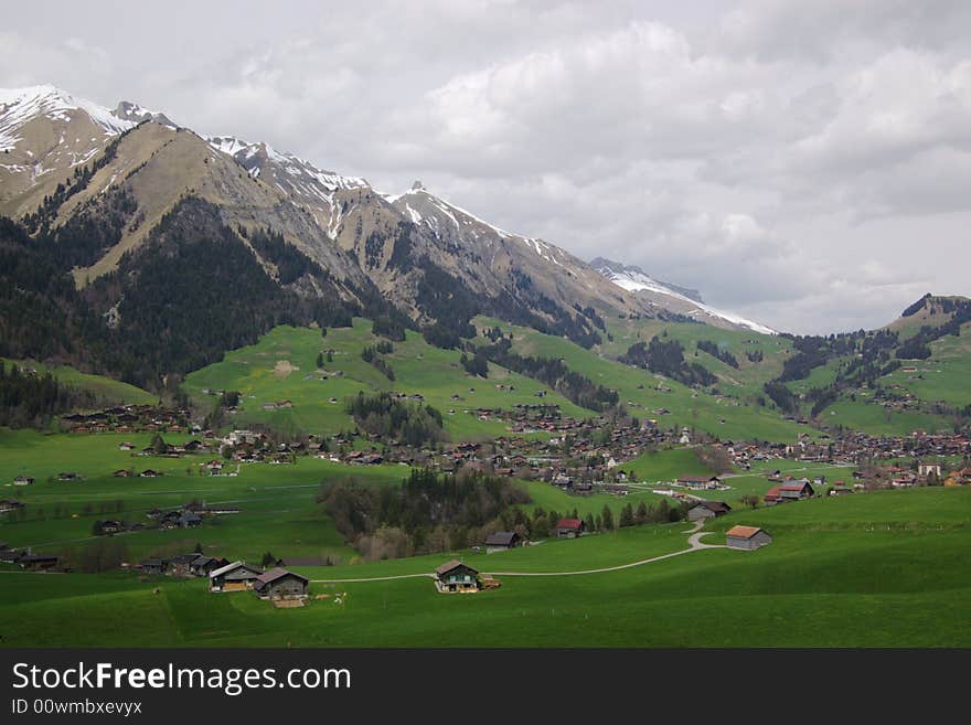 Mountain rural landscape, village in green slopes, Alps, Switzerland. Mountain rural landscape, village in green slopes, Alps, Switzerland.