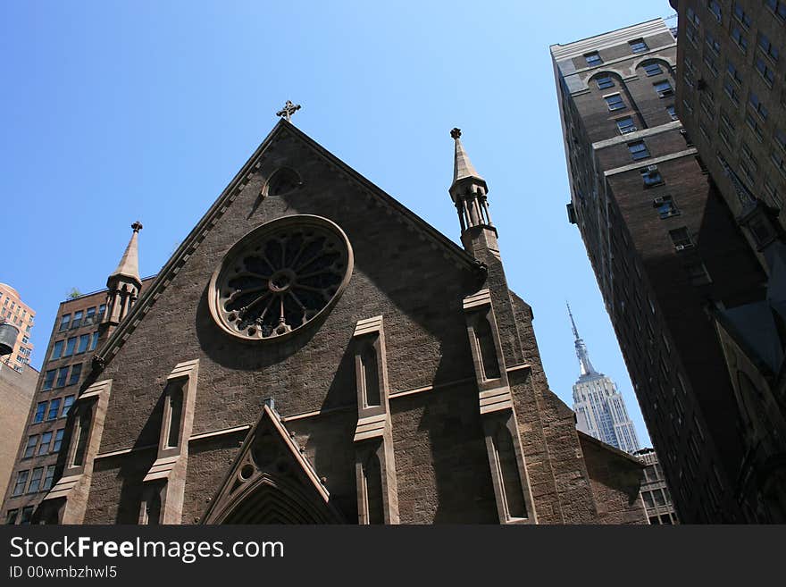 Church in Manhattan with the Empire State Building in the background. Church in Manhattan with the Empire State Building in the background.