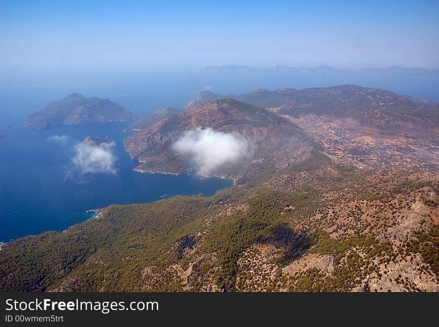 Aerial view on mountains, sea, sky and clouds. Aerial view on mountains, sea, sky and clouds