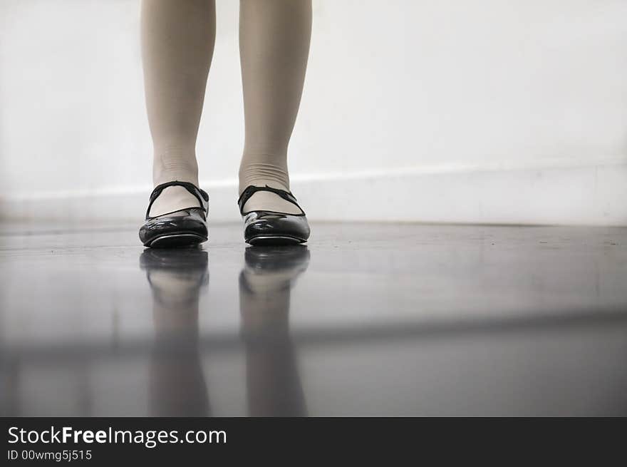 Young dancer in tap shoes... low angle shot of just feet and legs. Young dancer in tap shoes... low angle shot of just feet and legs