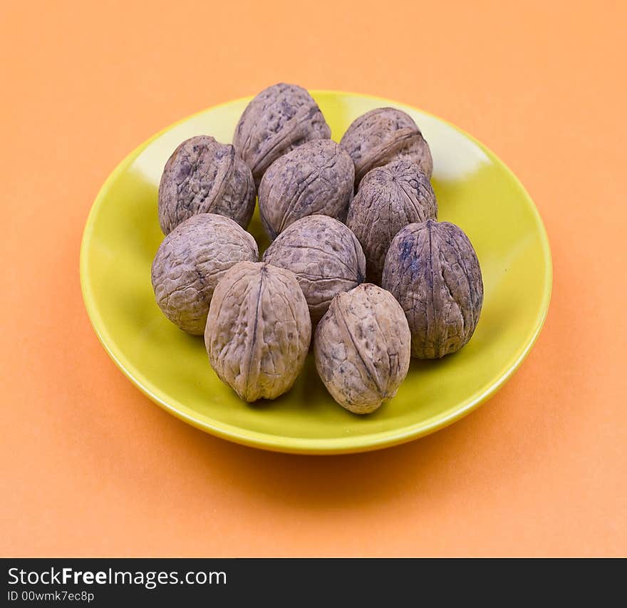 Walnuts on the orange background