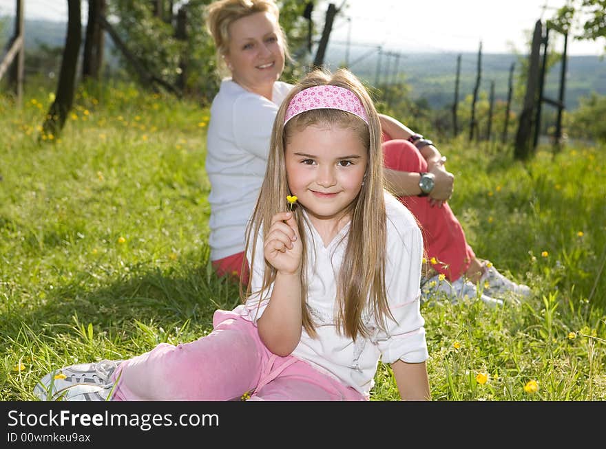 Little girl picking a flower for her mother. Little girl picking a flower for her mother