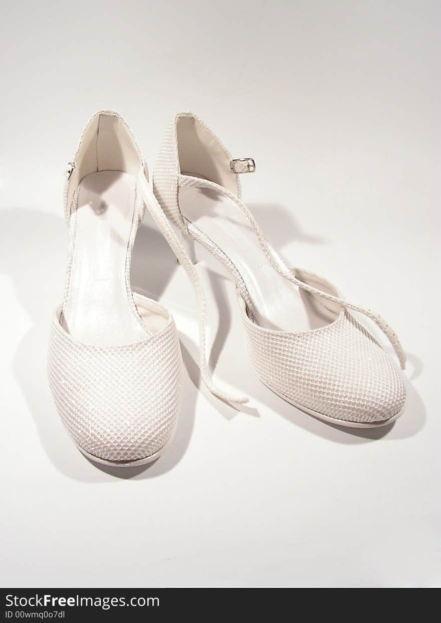 Isolated wedding shoes on white, białe buty ślubne, błyszczące, pantofelki. Isolated wedding shoes on white, białe buty ślubne, błyszczące, pantofelki