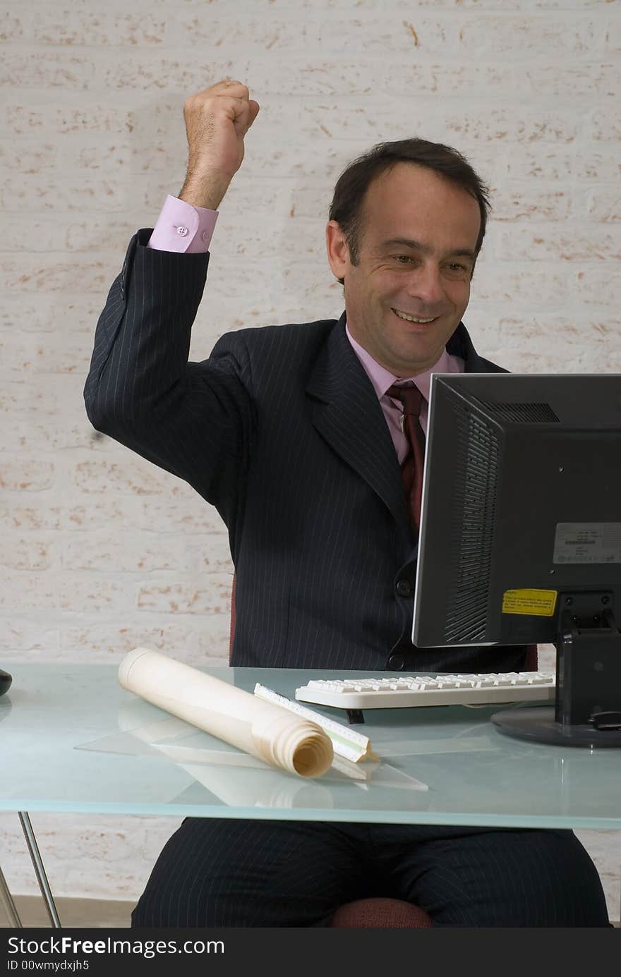 A shot of a businessman with his fist in the air in excitement. A shot of a businessman with his fist in the air in excitement.