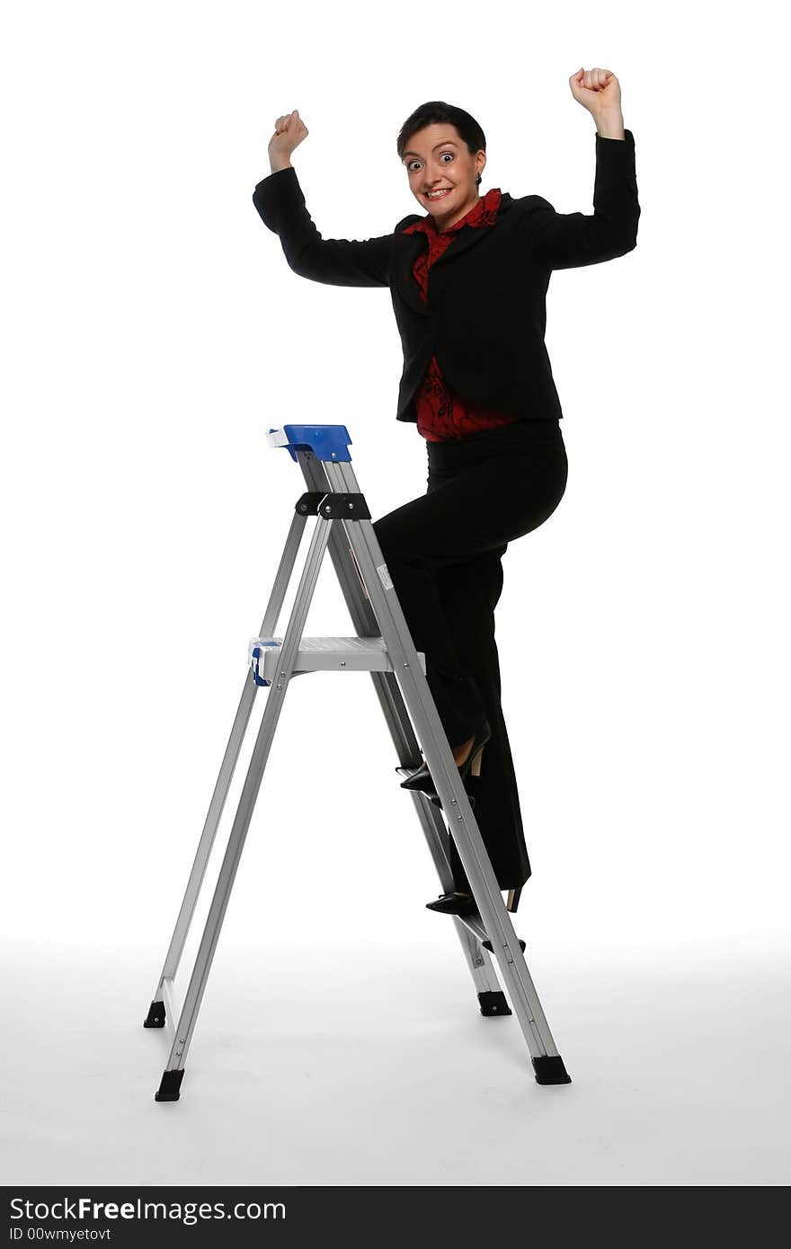 Woman in a business suit climbing up a step ladder with her fists in the air while smiling at the camera. Isolated against a white background. Woman in a business suit climbing up a step ladder with her fists in the air while smiling at the camera. Isolated against a white background