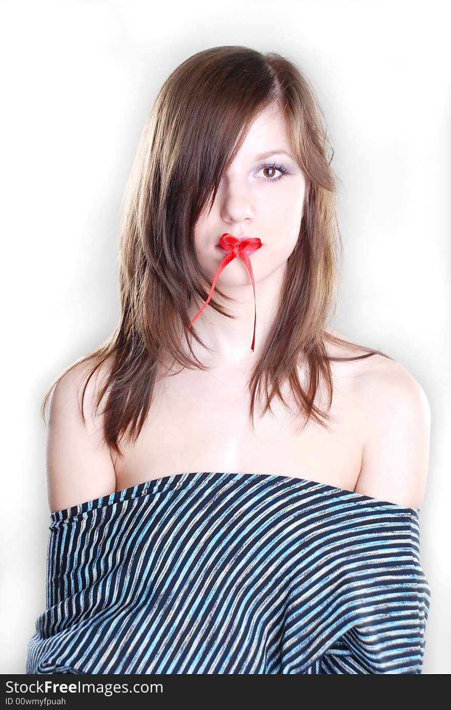 Woman with red bow on her lips at white background. Woman with red bow on her lips at white background