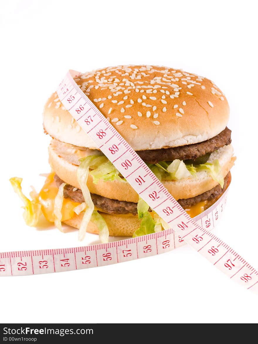 Bread with fried meat, cheese, onion, lettuce and measuring tape isolated on a  white background. Bread with fried meat, cheese, onion, lettuce and measuring tape isolated on a  white background.