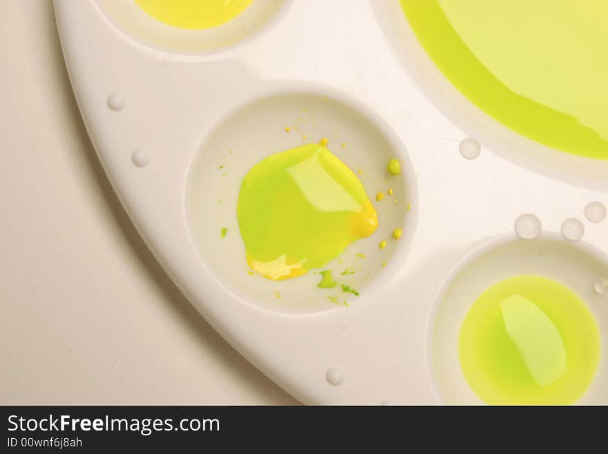 Paint palette with yellow and green watercolors.