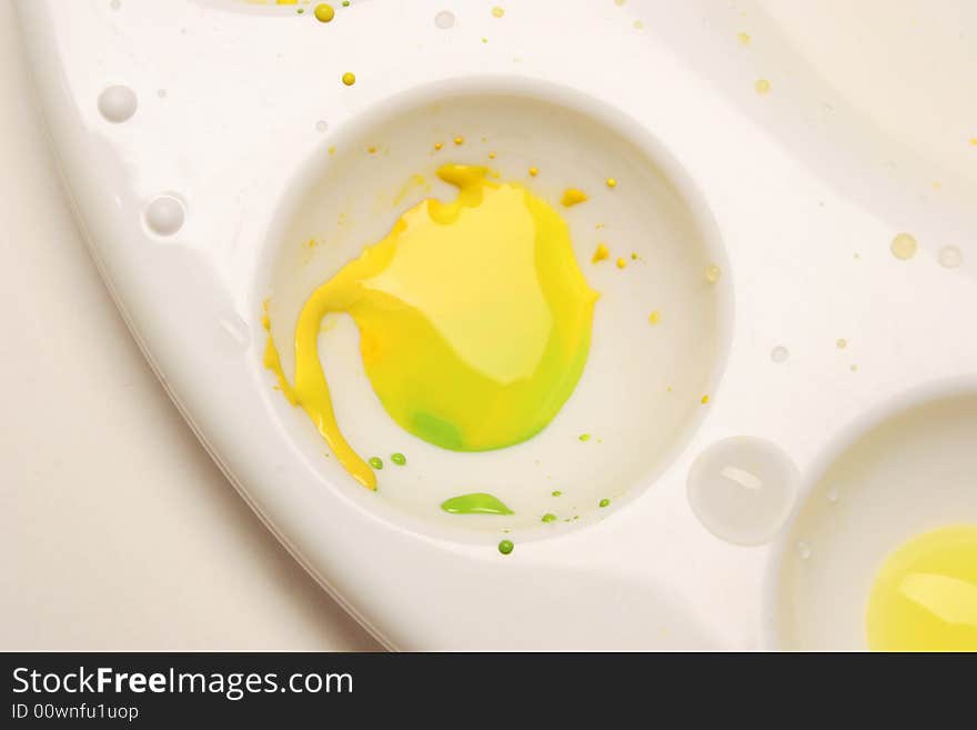 Paint palette with yellow and green watercolors.