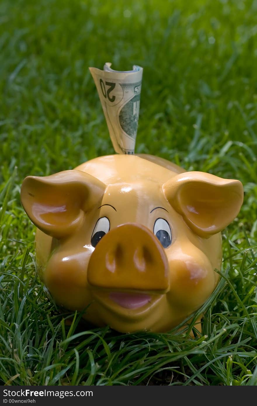 Piggy bank with money in upper slot