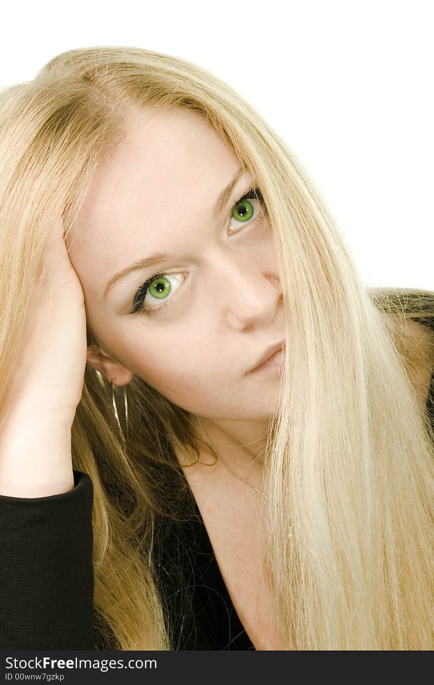 Young attractive green-eyed dreaming woman in black on white background. Young attractive green-eyed dreaming woman in black on white background