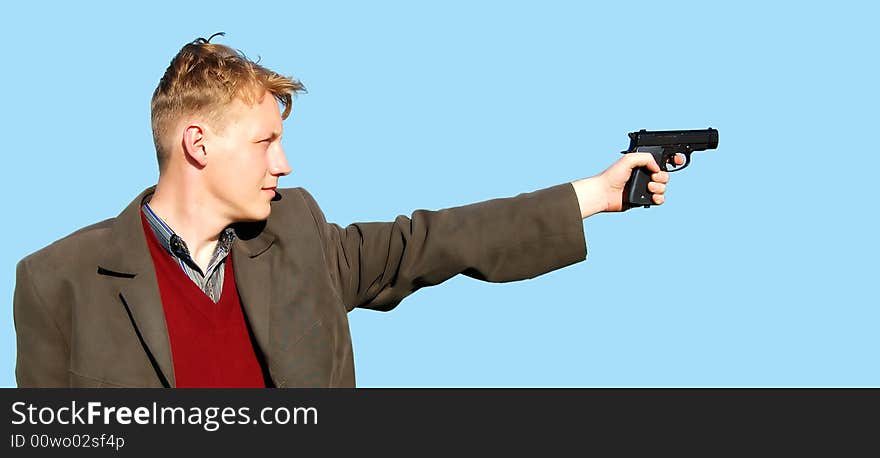 A young man standing with a gun