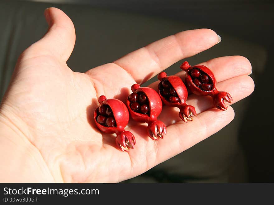 Fruits of a pomegranate on a palm. Fruits of a pomegranate on a palm