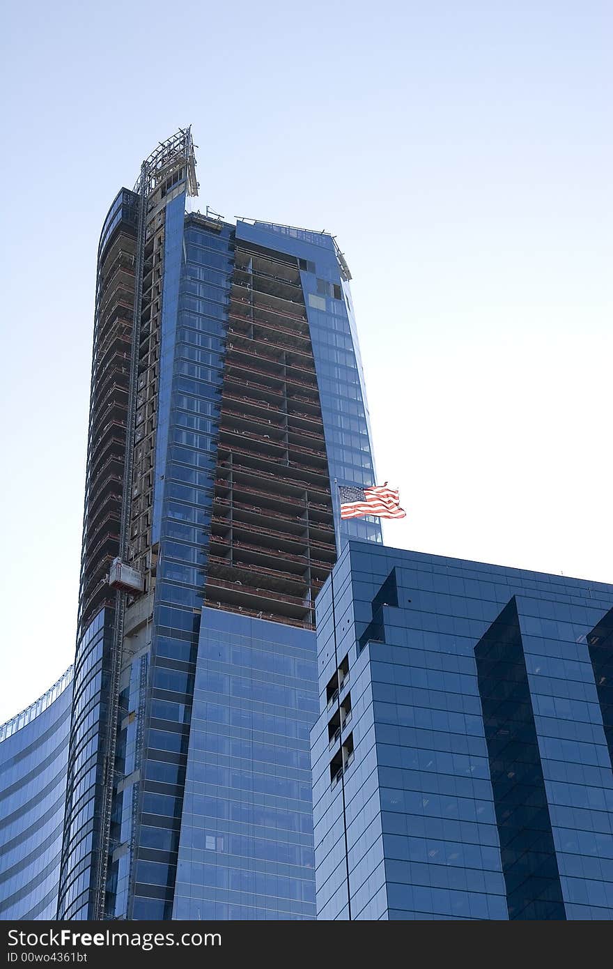 A new blue tower under construction with an American flag on top. A new blue tower under construction with an American flag on top