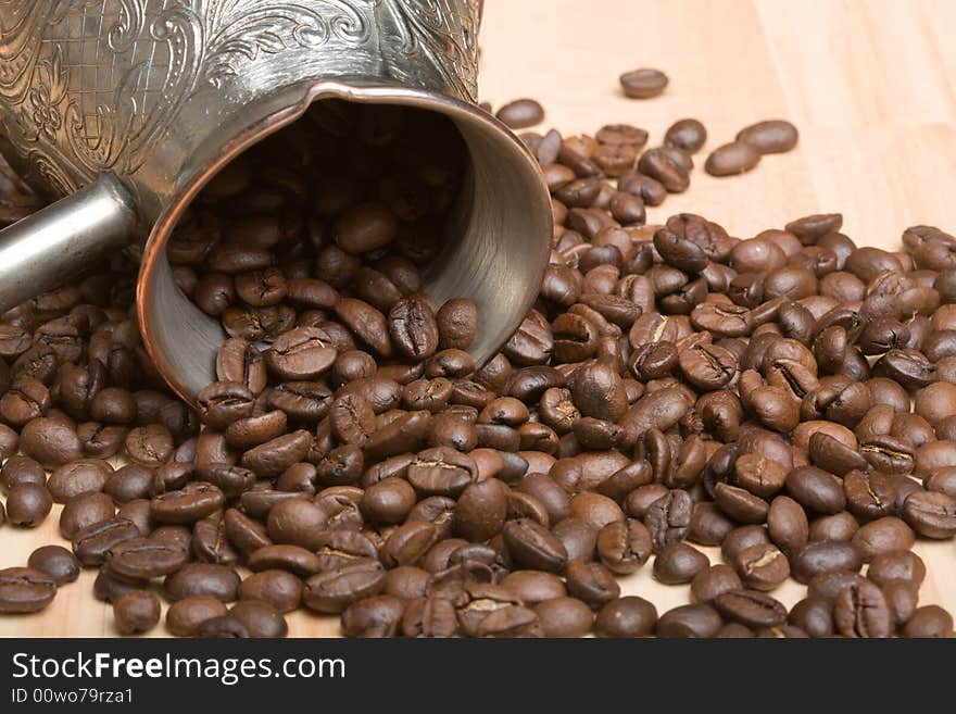 Cezve and roasted coffee beans on the table