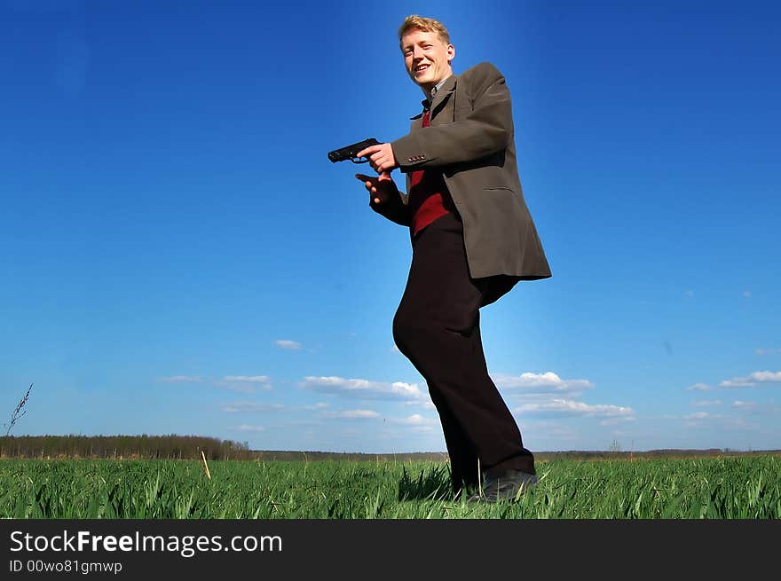 Young man walking with a gun. Young man walking with a gun.