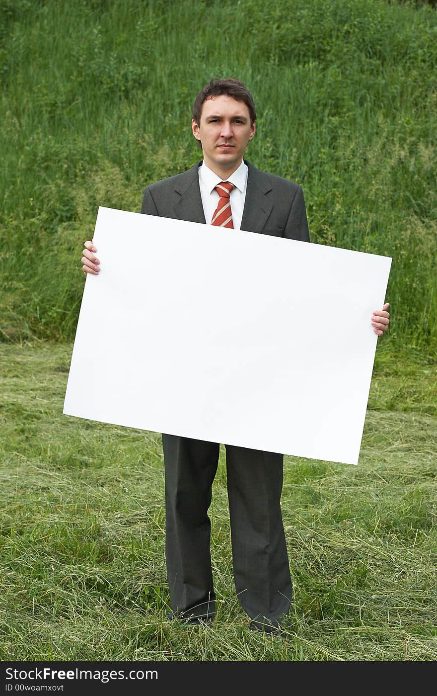 Businessman holding sheet of paper outdoor