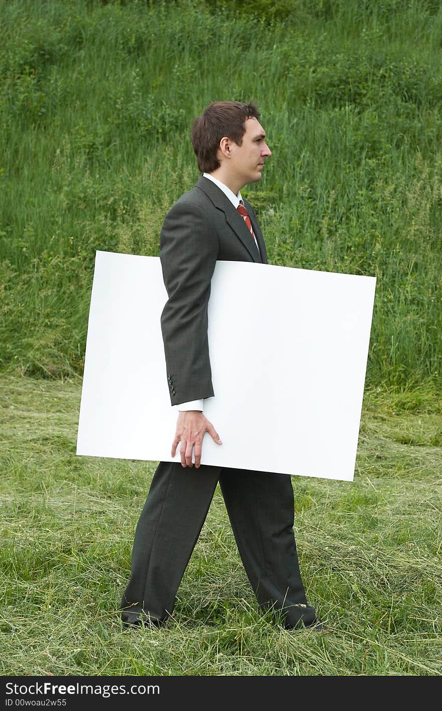 Businessman with sheet of paper outdoor