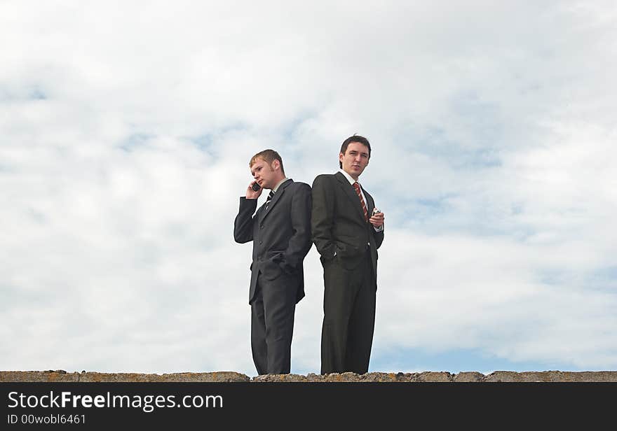 Businessmen talking under the skies. Businessmen talking under the skies