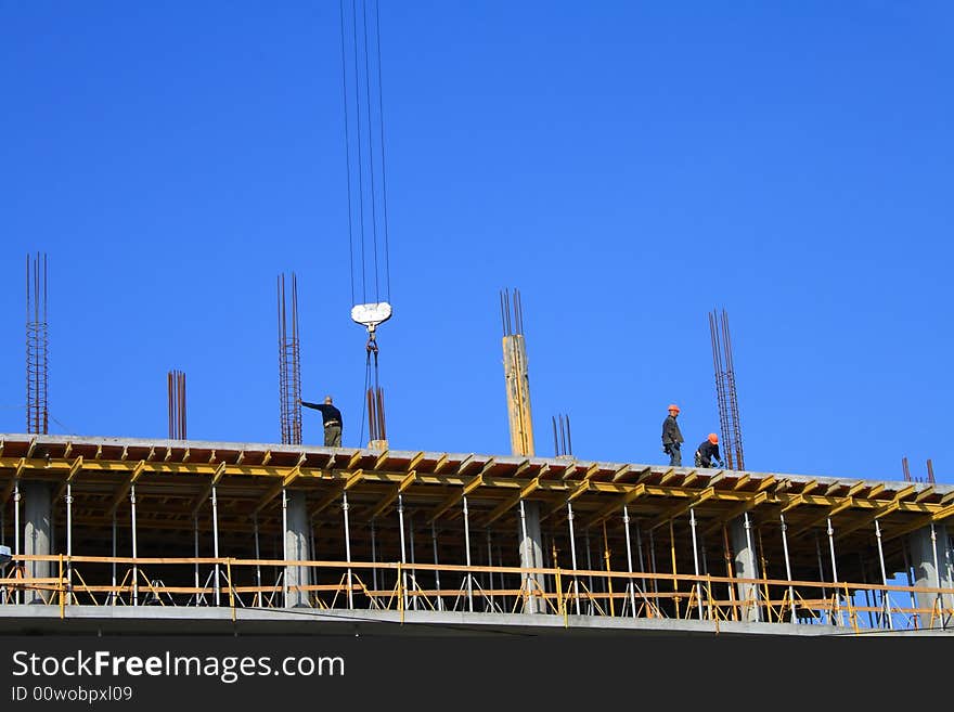 Hooker and concretors are working at new flat of building