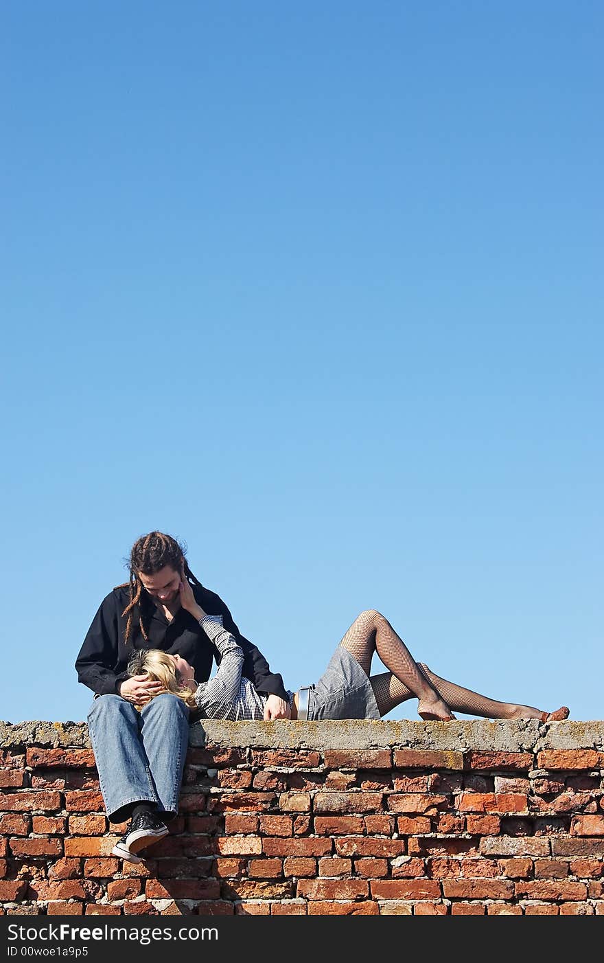 Woman lying on mans knees