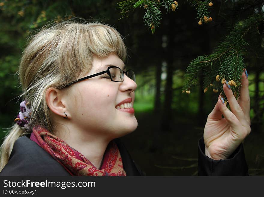 Caucasian girl by branches of evergreen fir-tree. Close-ups portrait. Caucasian girl by branches of evergreen fir-tree. Close-ups portrait.