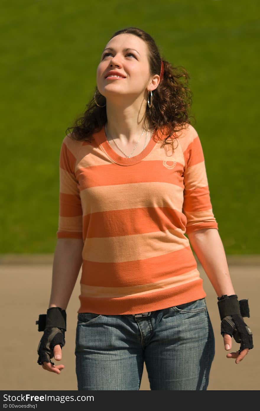 Smiling Sports Girl Outdoors on Green Background